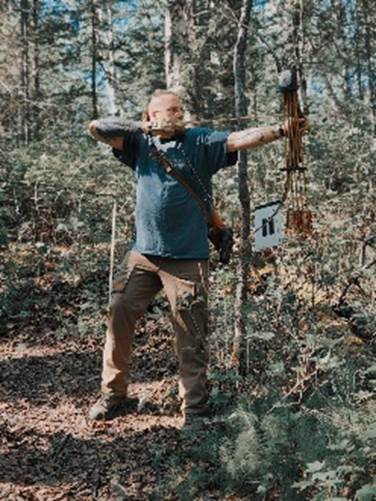 A person holding a bow and arrow

Description automatically generated with low confidence
